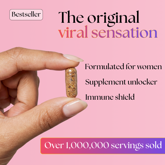 A hand with manicured nails holds a Bee Vitality 🐝 supplement capsule against a pink background. Text reads: Bestseller. The original viral sensation with Royal Jelly. Formulated for women. Immune shield. 1,000,000+ servings sold.
